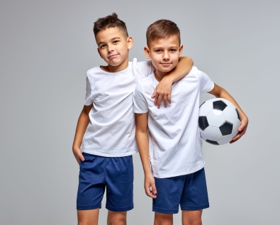 Two,Friendly,Children,Soccer,Players,Posing,At,Camera,Isolated,On